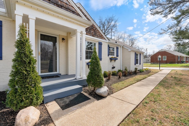 view of exterior entry featuring brick siding