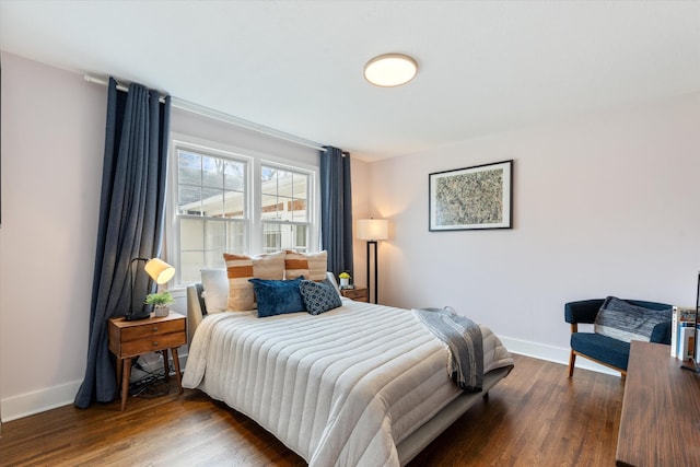 bedroom with wood finished floors and baseboards