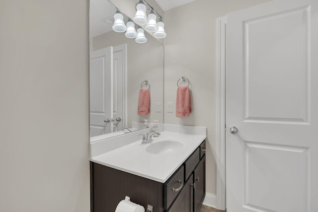 bathroom featuring a chandelier and vanity