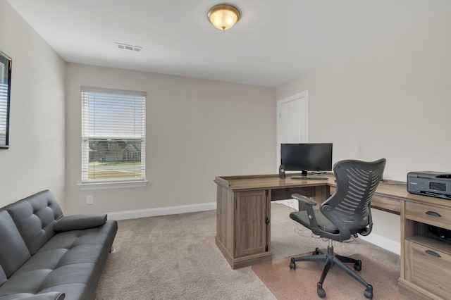 office space featuring visible vents, light colored carpet, and baseboards