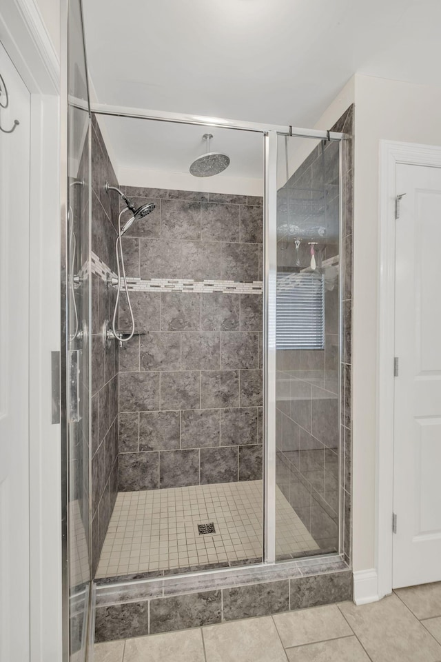 full bathroom featuring tile patterned floors and a stall shower