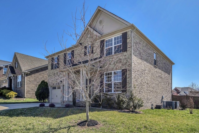 traditional home featuring fence, central AC, a front yard, driveway, and an attached garage