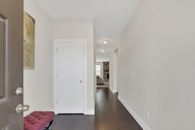 hall featuring dark wood-style floors and baseboards