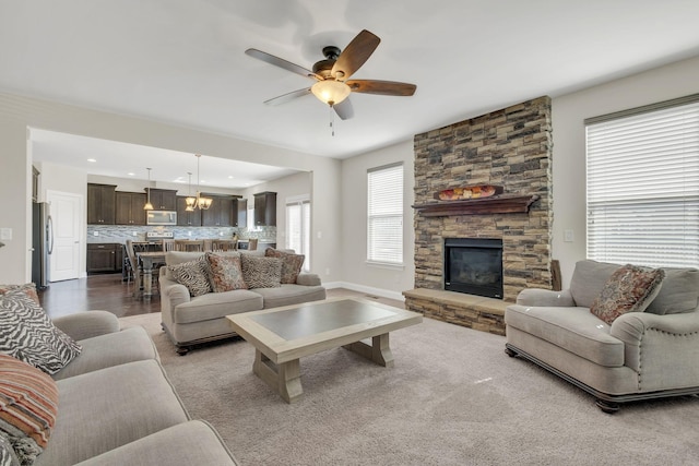 living room featuring recessed lighting, a fireplace, baseboards, and a ceiling fan