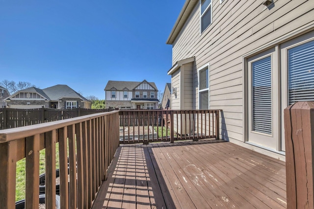 deck with a residential view and fence