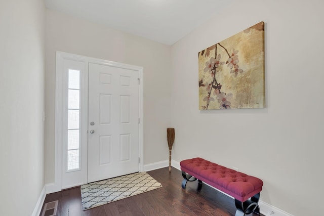 entryway featuring visible vents, baseboards, and wood finished floors