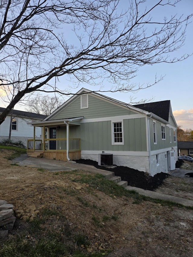 exterior space with central AC unit and a porch