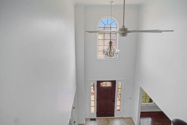 entryway featuring visible vents, baseboards, a high ceiling, and an inviting chandelier