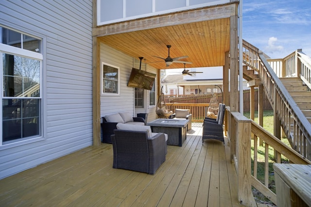 wooden terrace featuring stairway, a fire pit, ceiling fan, and fence