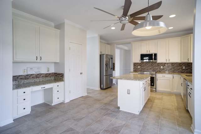 kitchen featuring a ceiling fan, built in study area, ornamental molding, appliances with stainless steel finishes, and tasteful backsplash