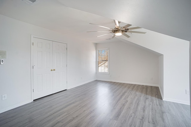 interior space with baseboards, wood finished floors, and ceiling fan