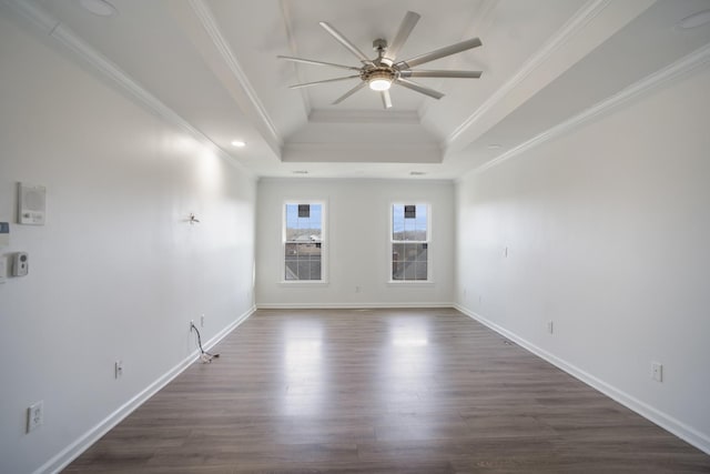 unfurnished room with dark wood-type flooring, ornamental molding, a tray ceiling, baseboards, and ceiling fan