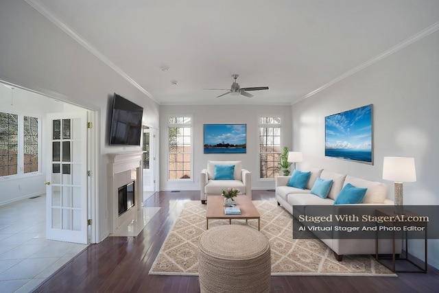 living room with ceiling fan, a high end fireplace, wood finished floors, and crown molding