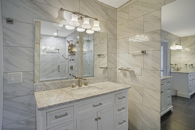 full bathroom featuring tile patterned flooring, tile walls, vanity, and a stall shower