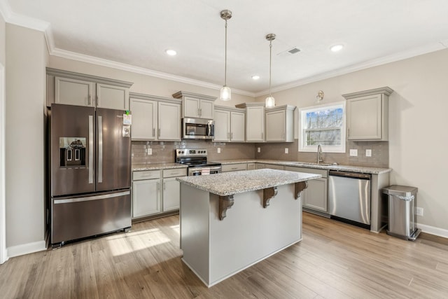 kitchen featuring visible vents, light wood-style flooring, a sink, gray cabinetry, and stainless steel appliances