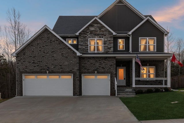 view of front of property with driveway, a porch, a yard, a garage, and brick siding