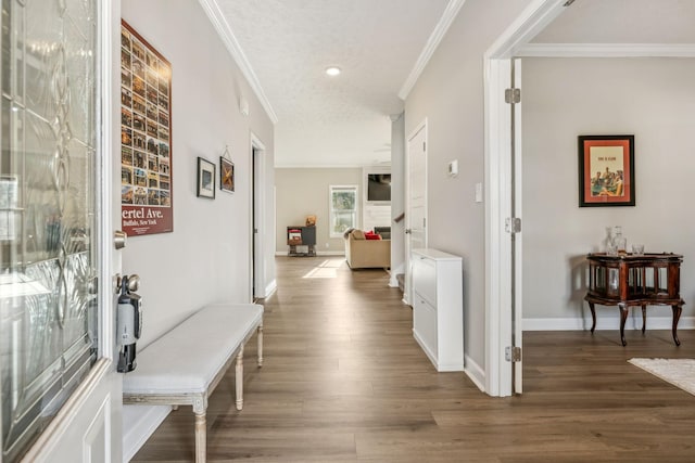 corridor with crown molding, baseboards, and wood finished floors