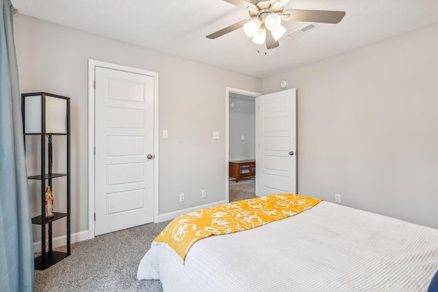 carpeted bedroom featuring visible vents, baseboards, and a ceiling fan