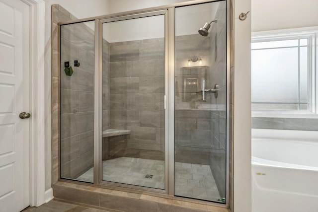 full bath featuring a garden tub and a stall shower