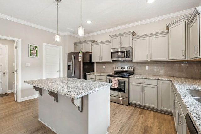 kitchen featuring ornamental molding, gray cabinetry, light wood-type flooring, and stainless steel appliances