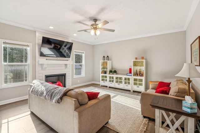 living room featuring ornamental molding, baseboards, and wood finished floors