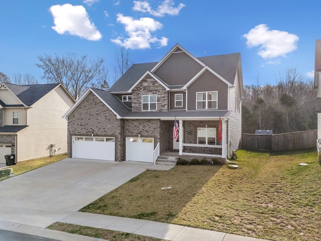 view of front of home featuring a porch, concrete driveway, a garage, and a front lawn