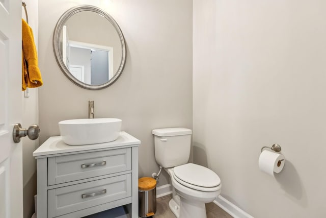 bathroom with tile patterned floors, toilet, vanity, and baseboards