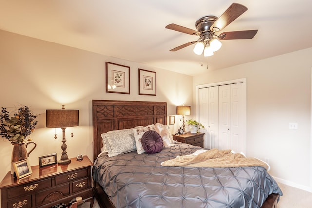 carpeted bedroom featuring baseboards, a closet, and ceiling fan