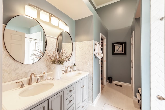 full bath featuring tile patterned flooring, visible vents, double vanity, and a sink