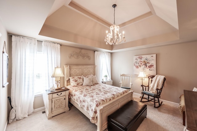 bedroom with light colored carpet, a raised ceiling, a notable chandelier, and baseboards