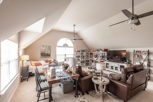 living room featuring vaulted ceiling, light colored carpet, and ceiling fan