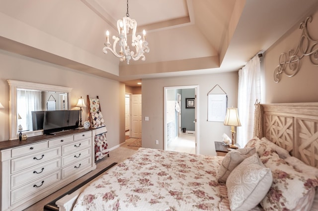 bedroom with a raised ceiling, multiple windows, and a chandelier