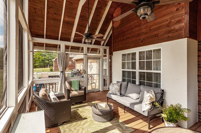 sunroom / solarium featuring lofted ceiling with beams, wood ceiling, and ceiling fan