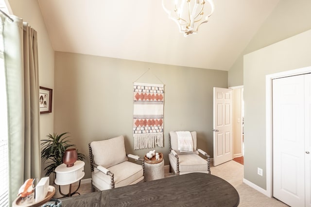 living area featuring light carpet, an inviting chandelier, baseboards, and lofted ceiling