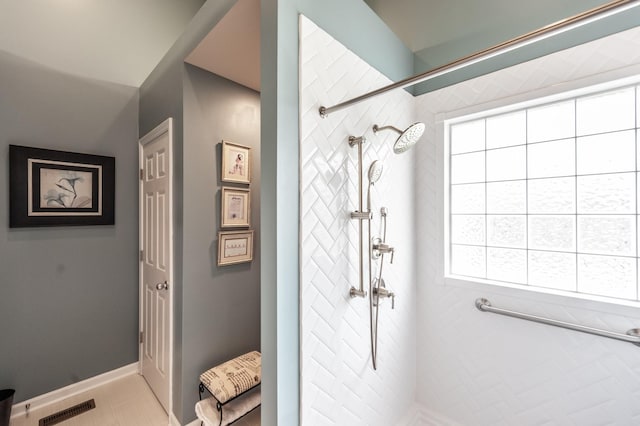 full bath featuring visible vents, baseboards, and a tile shower