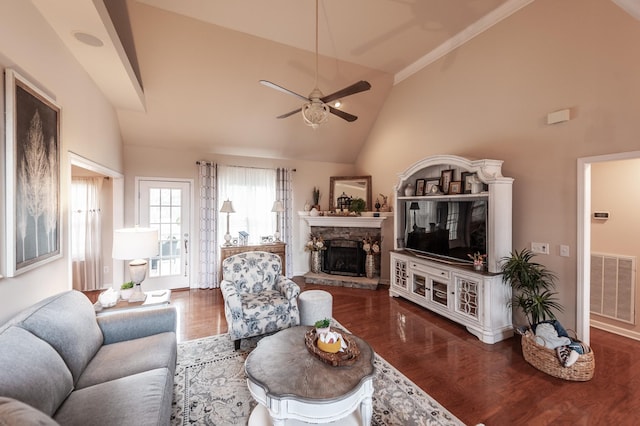 living area with wood finished floors, visible vents, a ceiling fan, lofted ceiling, and a fireplace