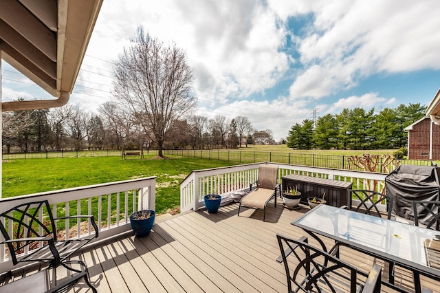 wooden terrace with a lawn, area for grilling, a fenced backyard, and outdoor dining space