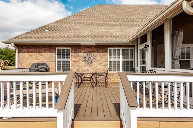 wooden terrace featuring a grill