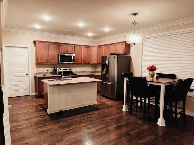 kitchen with a kitchen island with sink, appliances with stainless steel finishes, crown molding, light stone countertops, and dark wood-style flooring