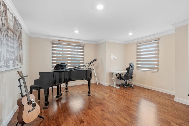 workout room with hardwood / wood-style floors, crown molding, recessed lighting, and baseboards