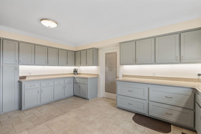 kitchen featuring gray cabinetry and ornamental molding