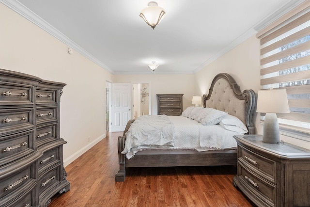 bedroom featuring dark wood finished floors, crown molding, and baseboards