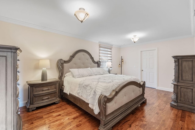 bedroom featuring baseboards, light wood-style floors, and crown molding