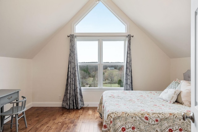 bedroom with hardwood / wood-style flooring, baseboards, and vaulted ceiling
