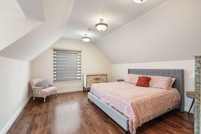 bedroom featuring visible vents, baseboards, lofted ceiling, and wood-type flooring