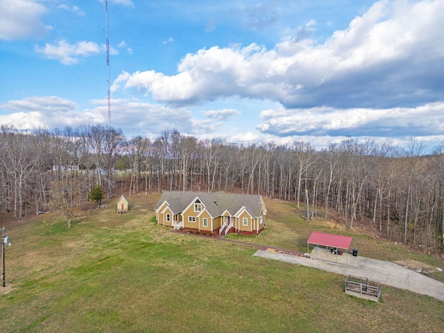 birds eye view of property with a wooded view