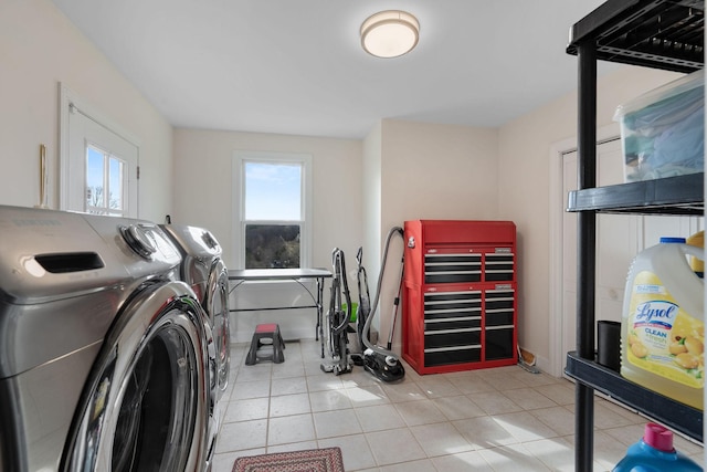 laundry room featuring a wealth of natural light, washing machine and dryer, laundry area, and light tile patterned floors