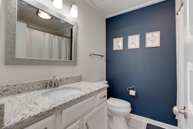 full bath featuring vanity, tile patterned floors, toilet, and baseboards