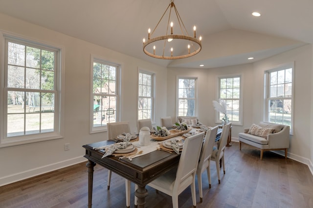 dining space featuring an inviting chandelier, wood finished floors, baseboards, and lofted ceiling