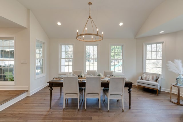dining space featuring an inviting chandelier, recessed lighting, wood finished floors, and vaulted ceiling